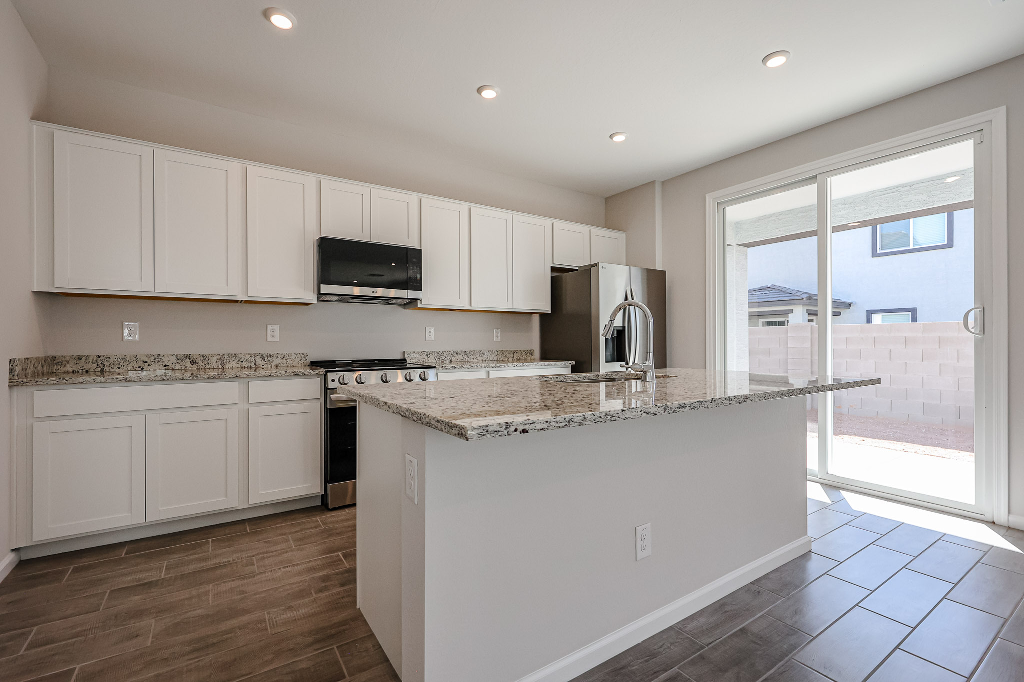 A kitchen with white cabinets.
