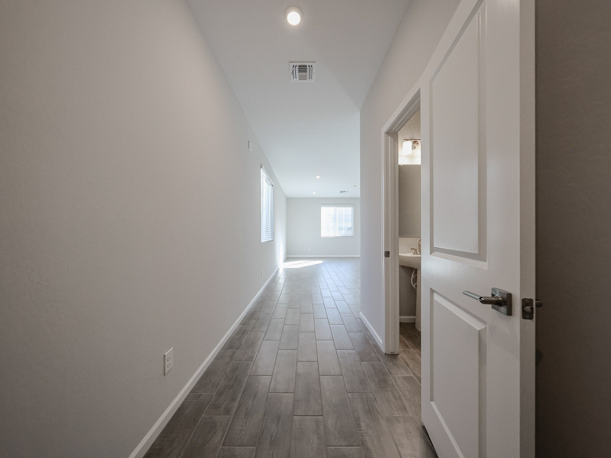 A hallway with white doors.