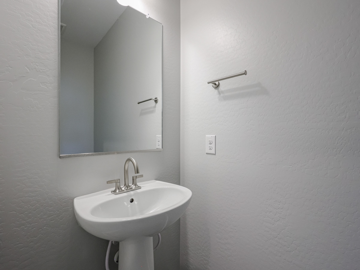 A bathroom with a mirror and sink.