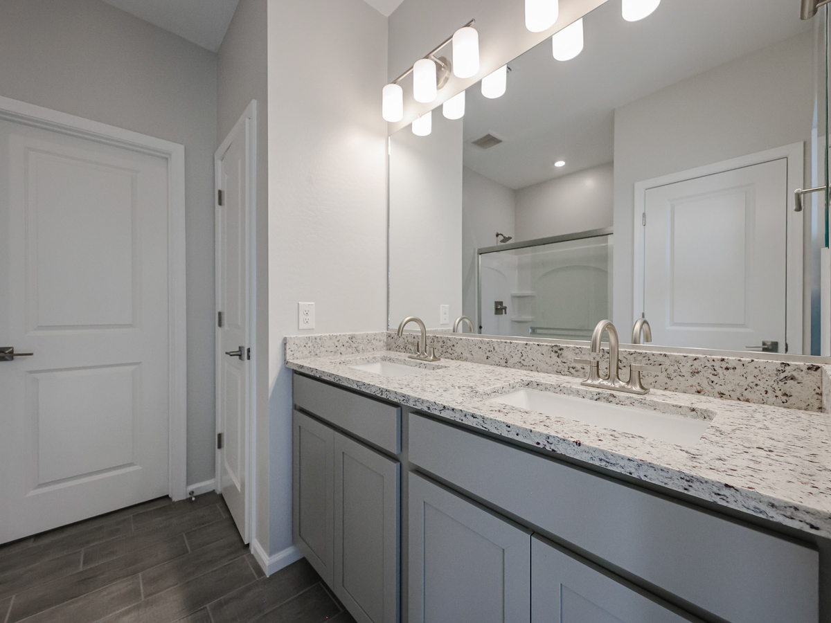 A bathroom with a large mirror.