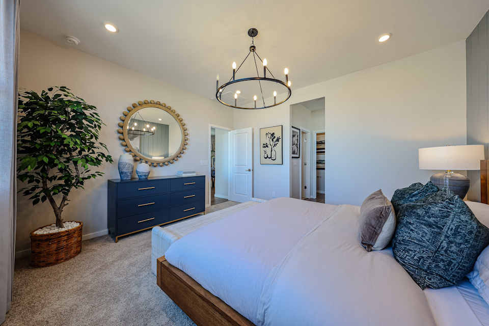 A large bedroom with a large mirror.