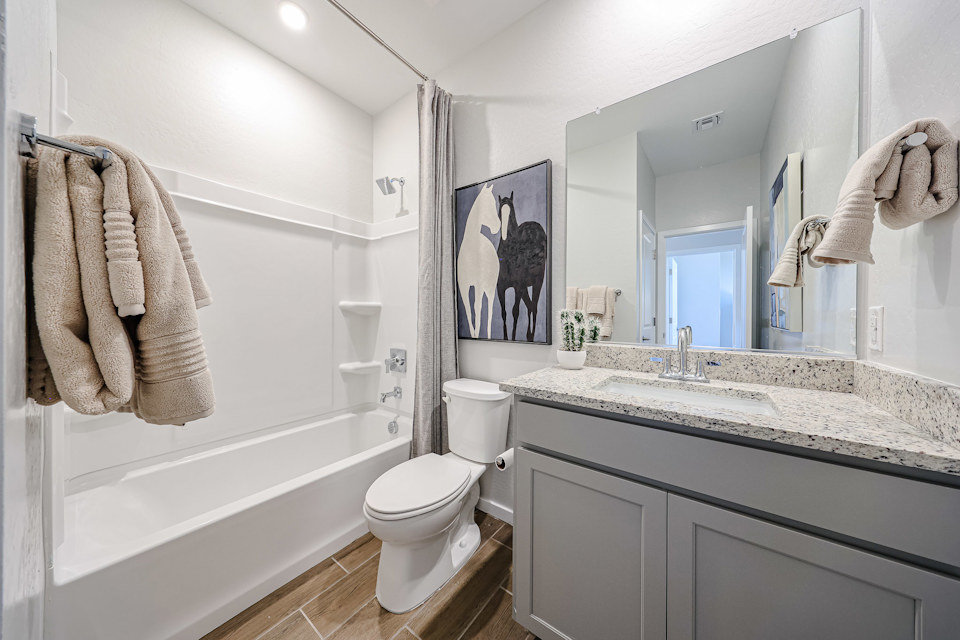 A bathroom with a large mirror.
