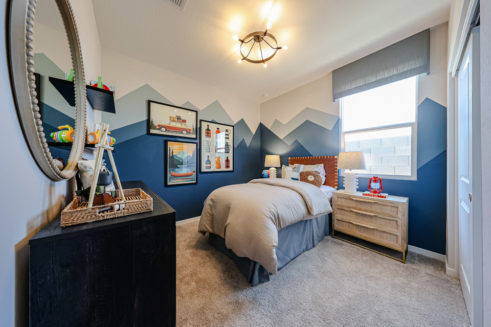 A bedroom with a bed and dresser.