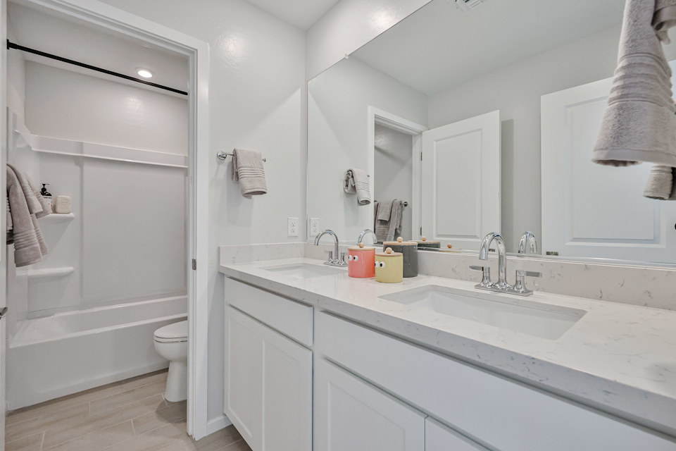 A bathroom with a tub sink and toilet.