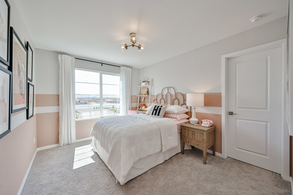 A bedroom with a large window.