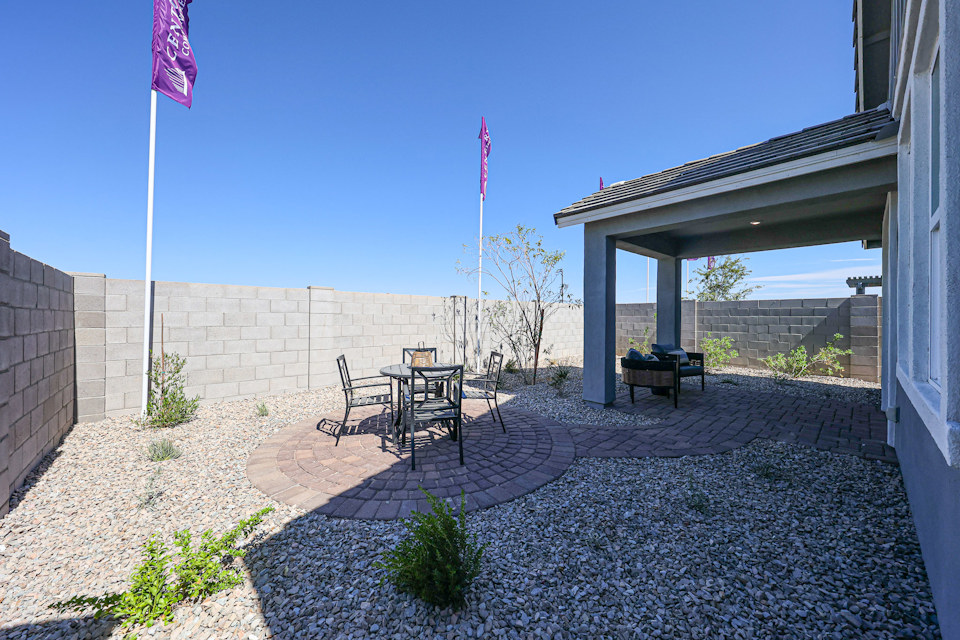 A patio with a table and chairs and a flag on it.