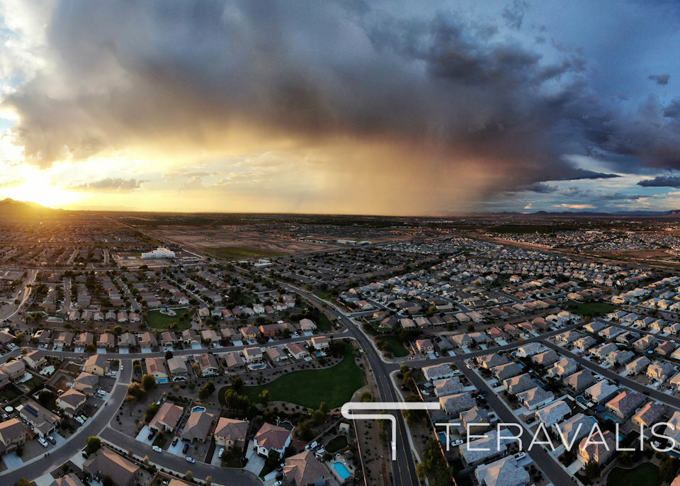 A city with many buildings and a body of water in the background.