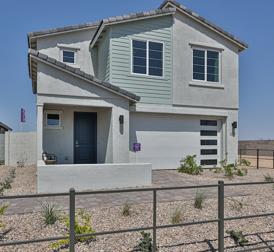 A house with a fence in front.