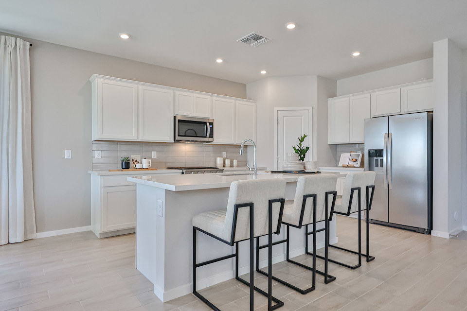 A kitchen with white cabinets.