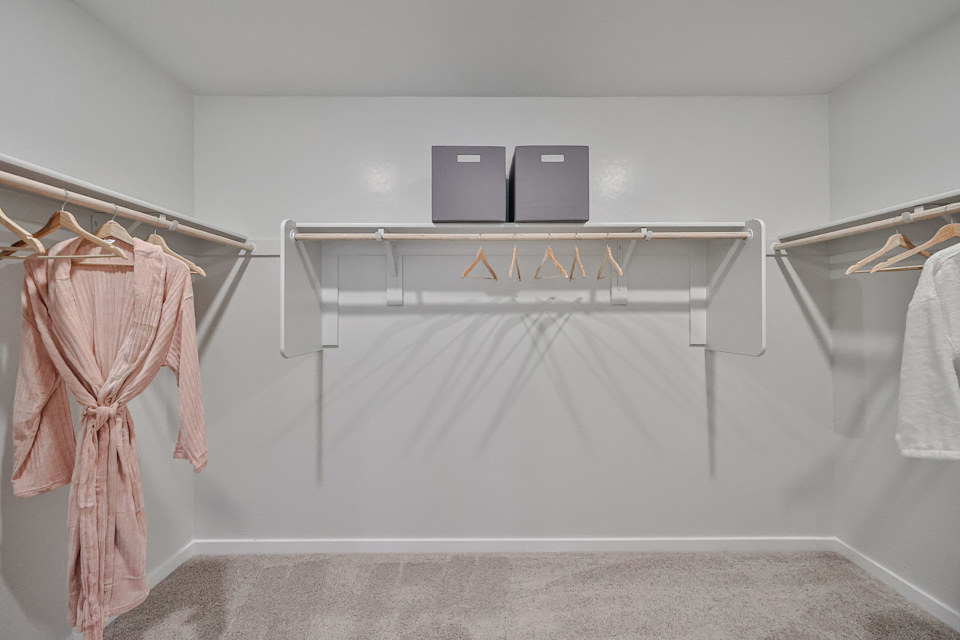 A white room with a white wall and a pink towel on a swinger.