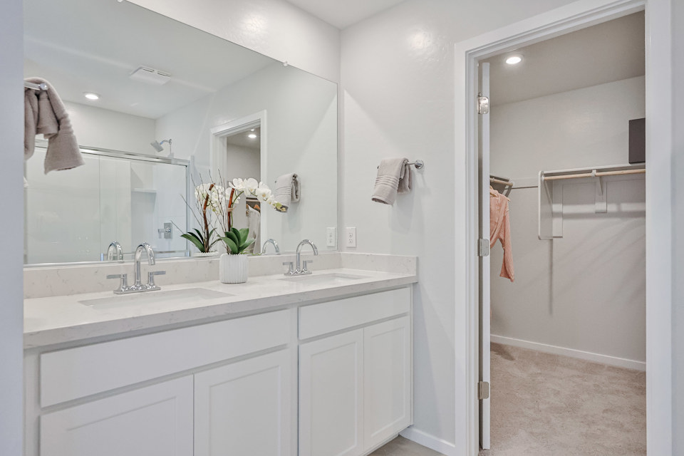 A bathroom with a sink and a shower unit.