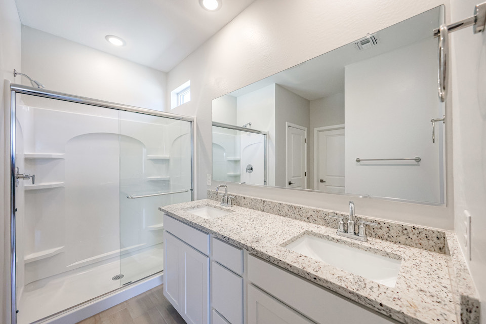 A bathroom with a large mirror.
