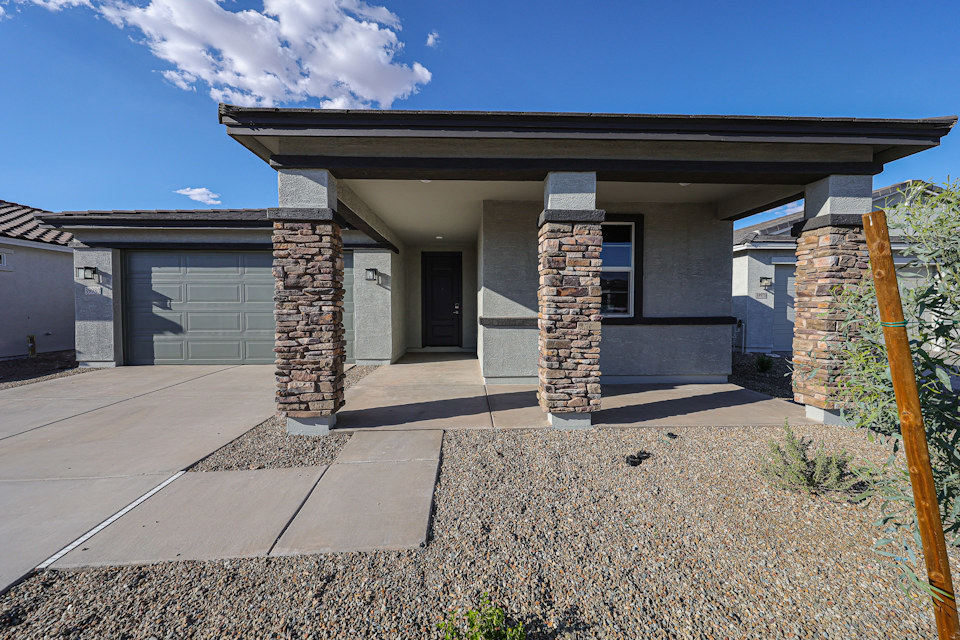 A house with a stone patio.