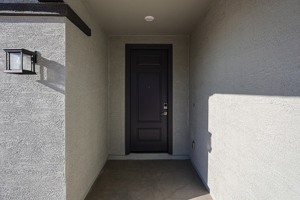 A dark room with a black door.