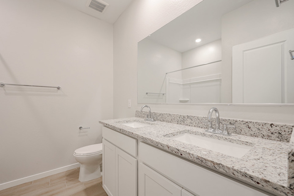 A bathroom with a marble countertop.