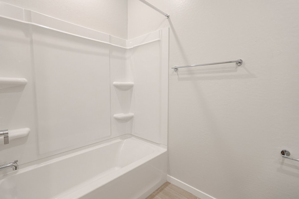 A bathroom with a bathtub and toilet.