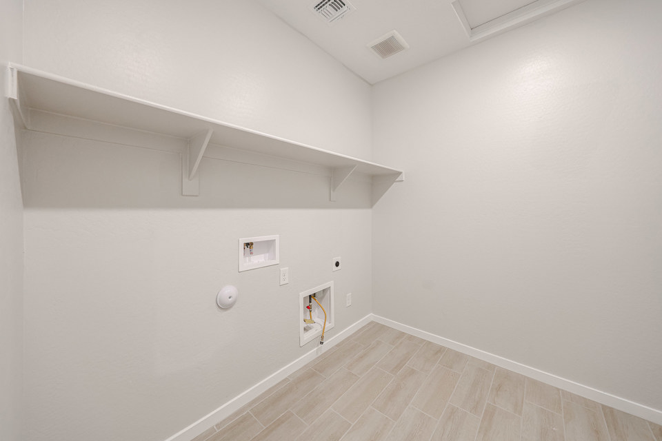 A room with a wood floor and white walls.