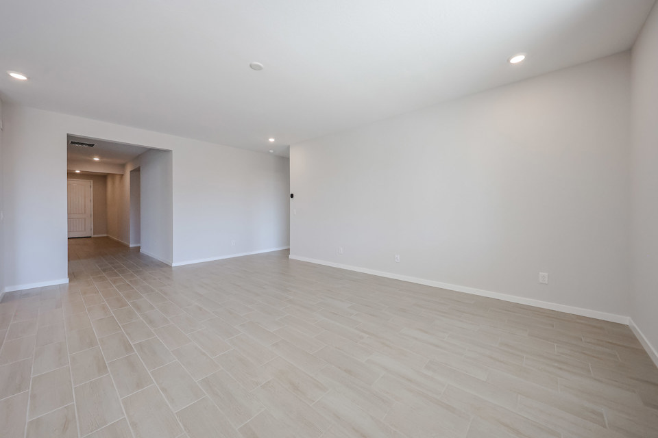 A room with a wood floor and white walls.