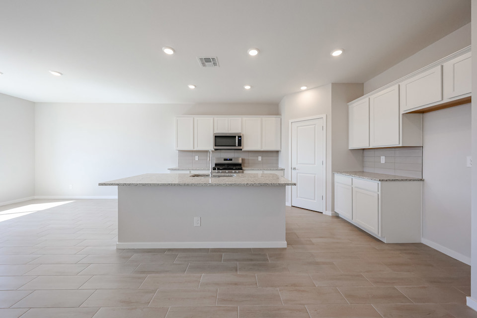 A kitchen with white cabinets.