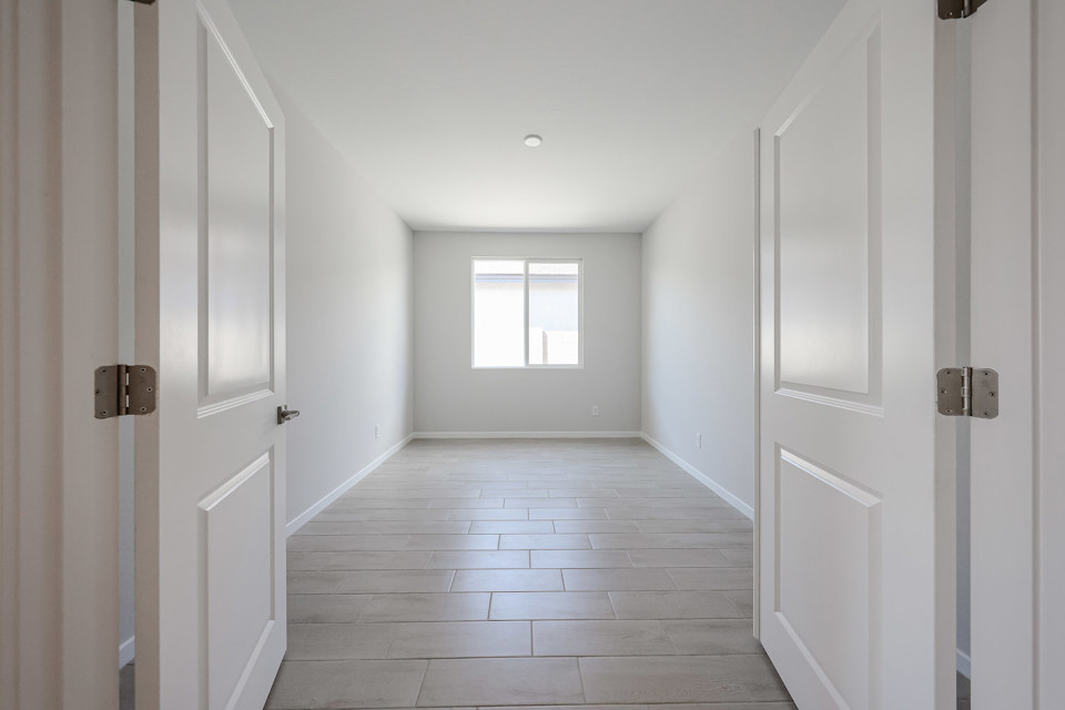 A hallway with white doors.