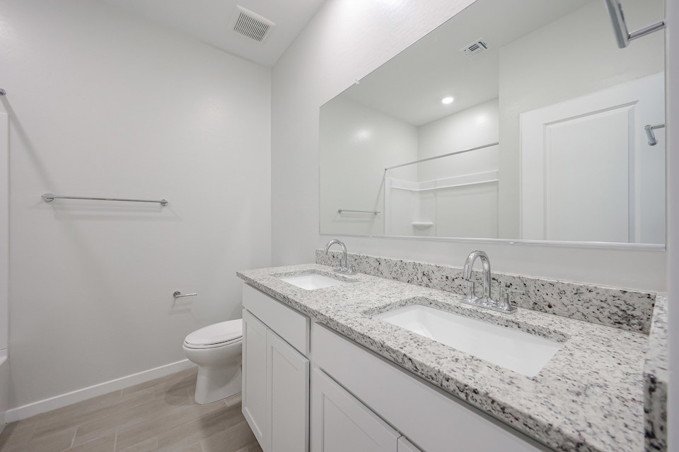 A bathroom with a marble countertop.