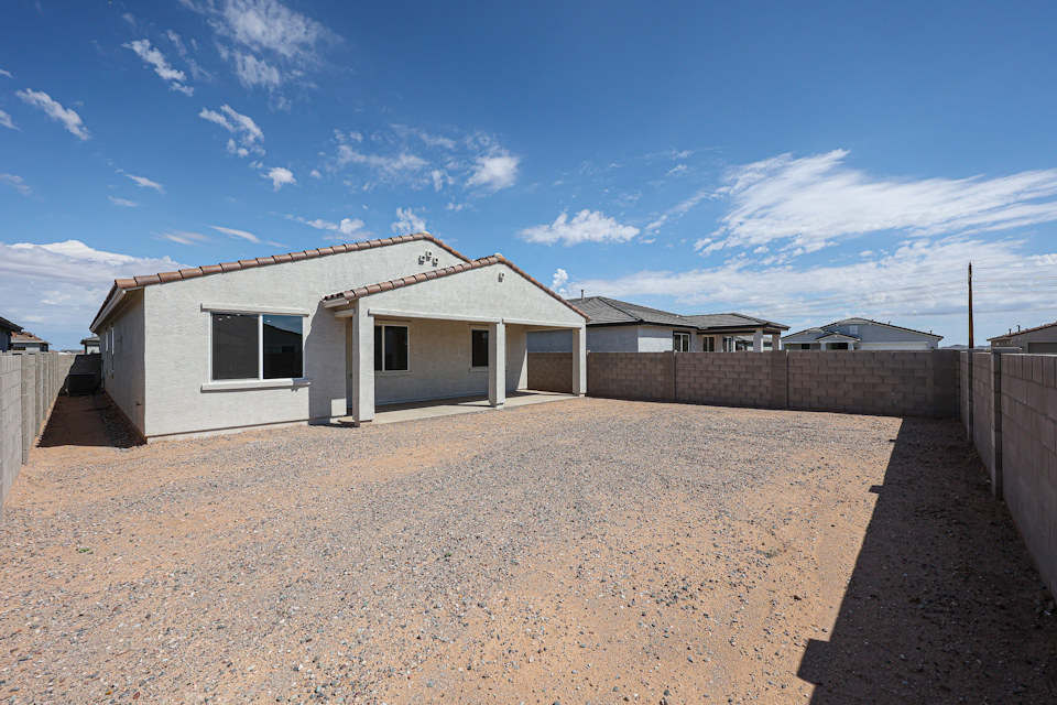 A house with a dirt yard.