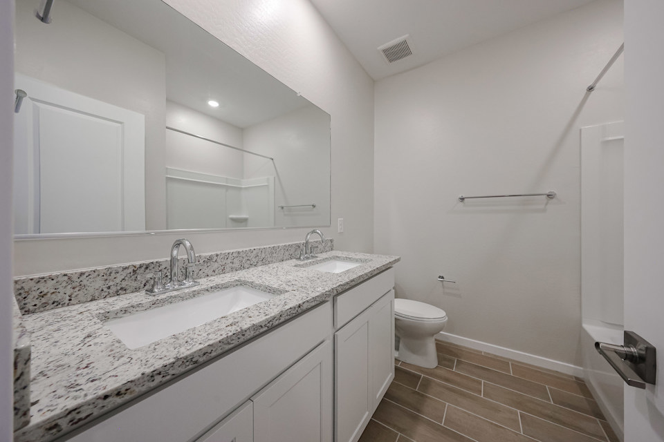 A bathroom with a large mirror.