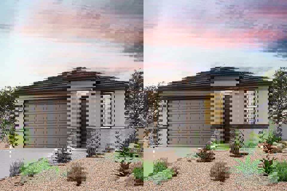 A house with a gravel driveway.