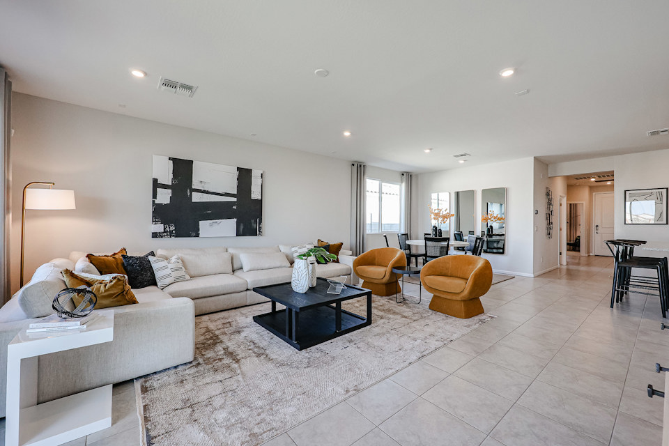 A living room with a large white couch and a coffee table.