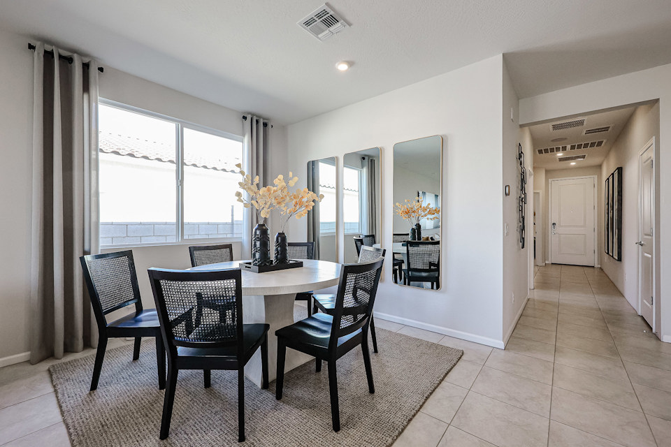 A dining room with a table and chairs.