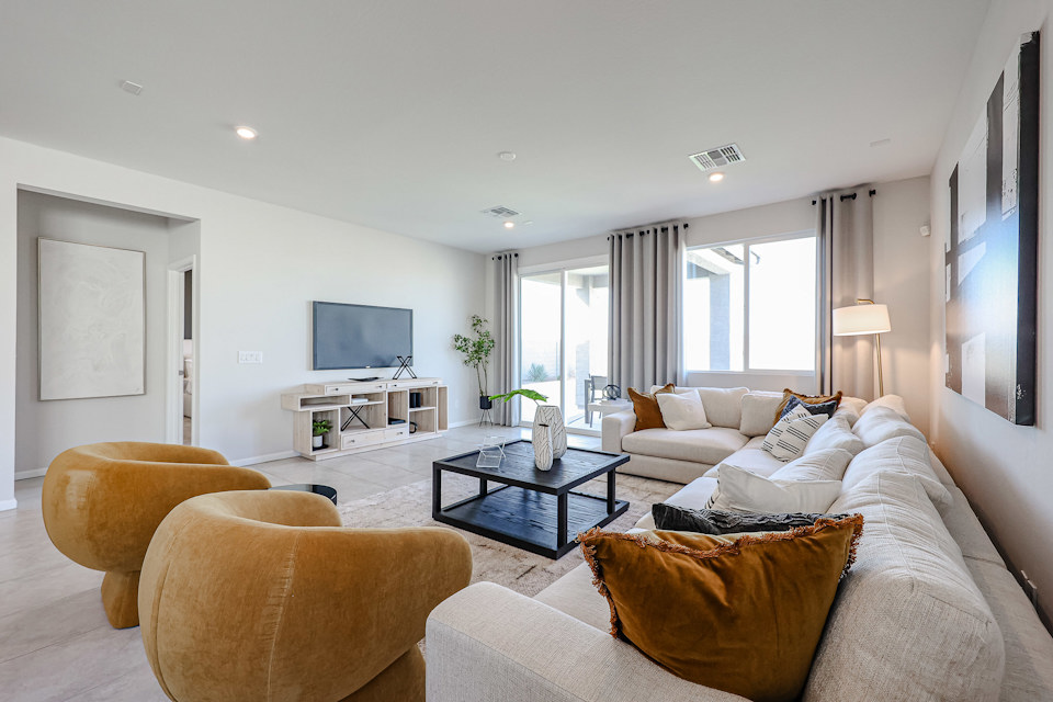A living room with a large tv and couches.