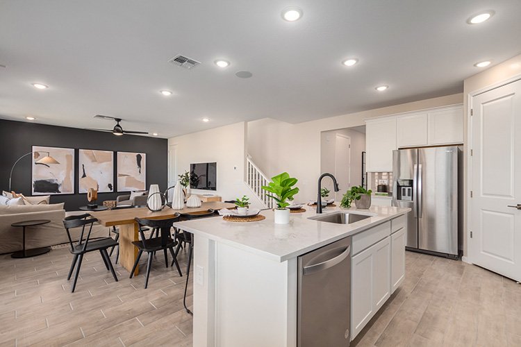A kitchen with a table and chairs.