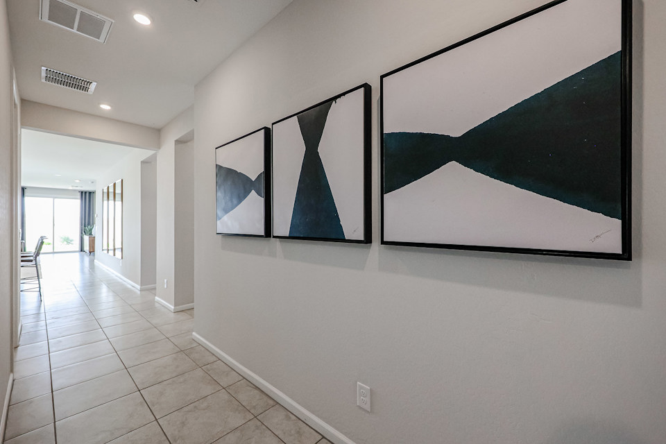 A white wall with a black and white painting on it.