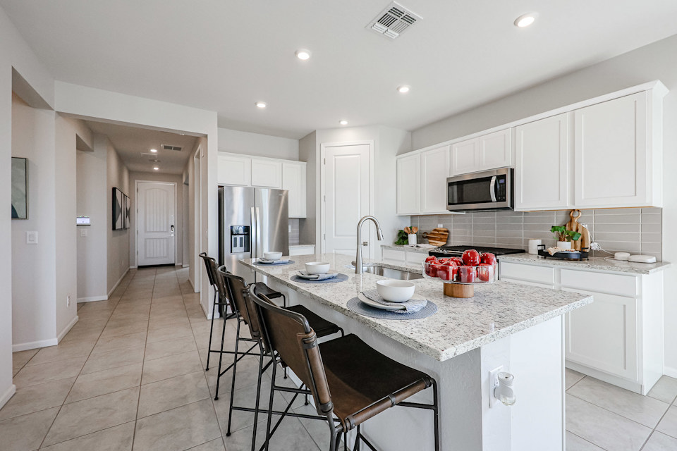 A kitchen with white cabinets.