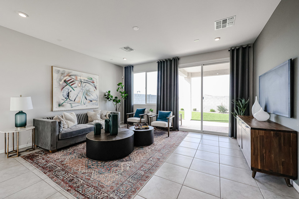 A living room with a large rug.