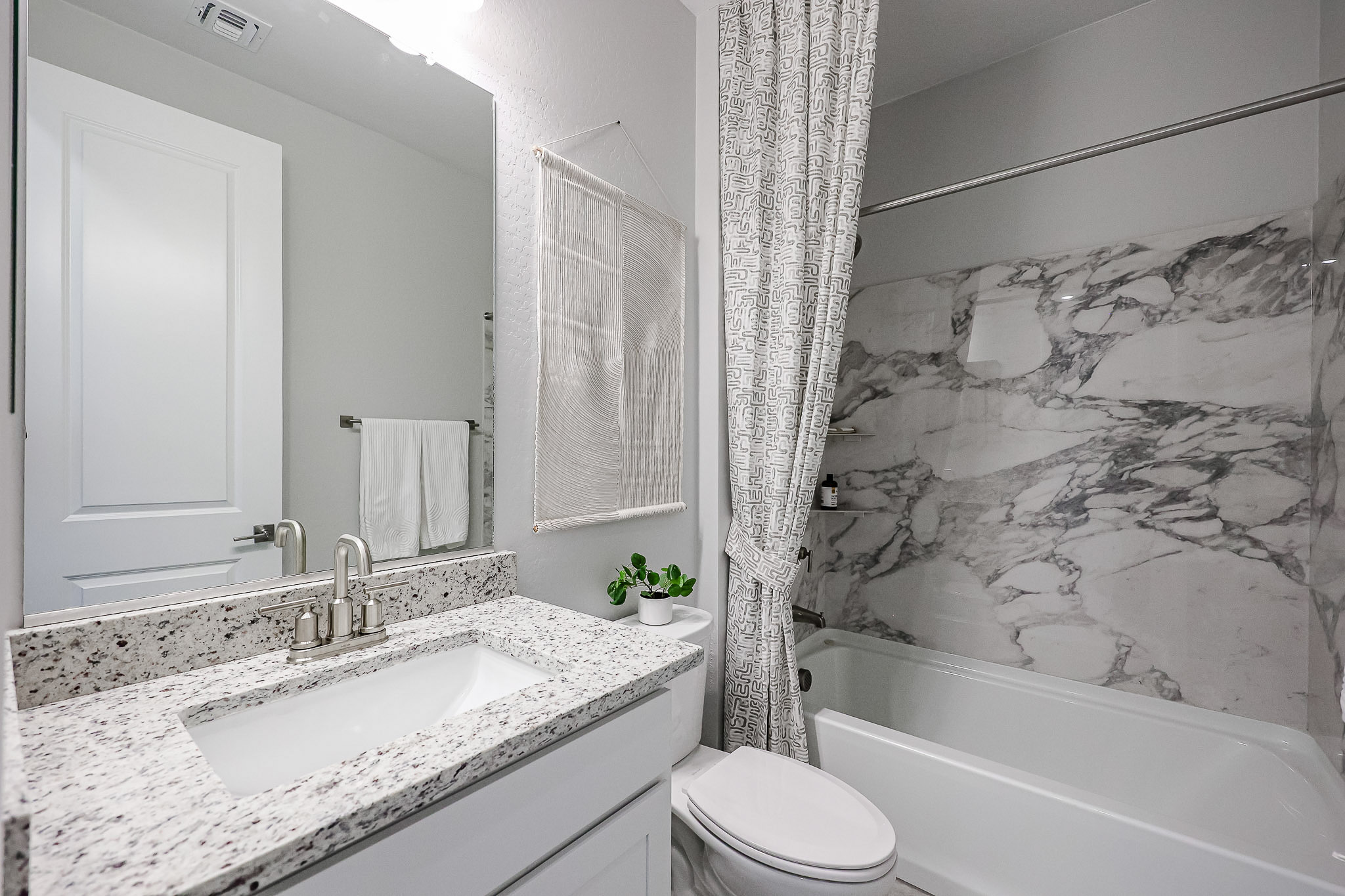 A bathroom with a tub sink and toilet.