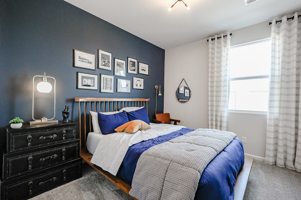 A bedroom with a bed and a dresser.