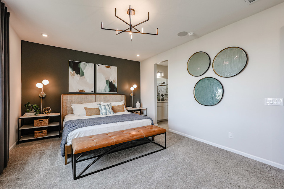 A bedroom with a bed and a mirror.