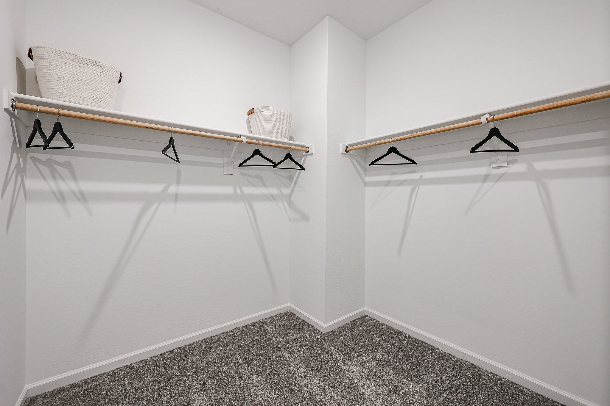 A white room with a bed and a chair.