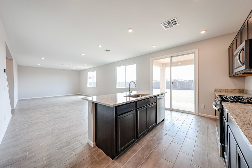 A kitchen with a wood floor.