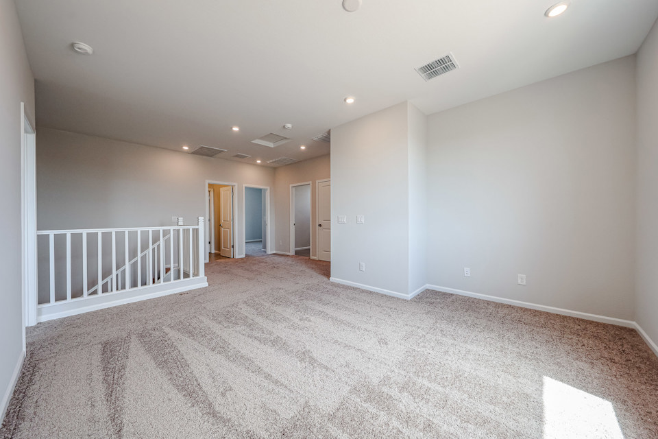 A long hallway with white walls.