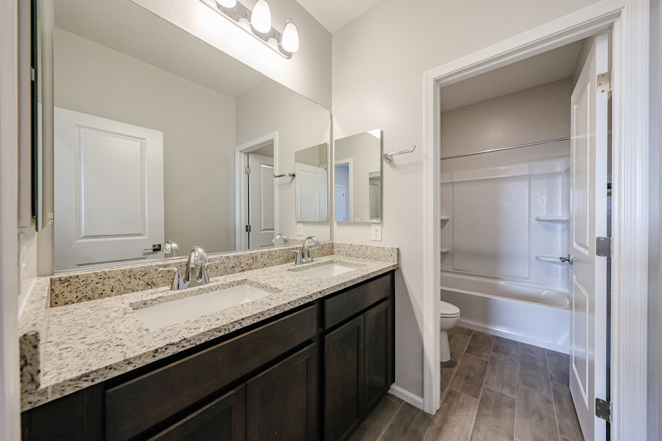 A bathroom with a marble countertop.