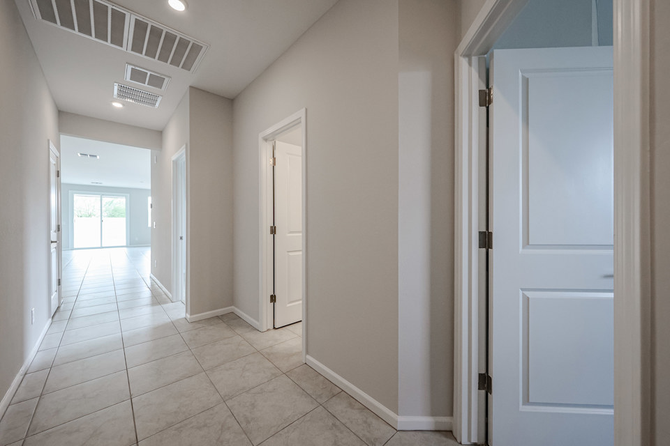 A hallway with white doors.