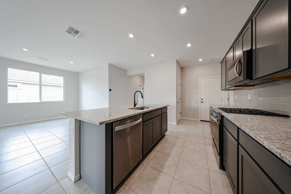 A kitchen with marble counters.