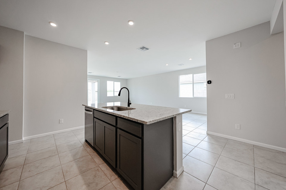 A kitchen with a marble countertop.