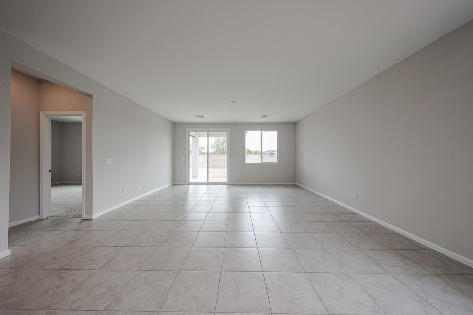 A room with a tile floor and a door.