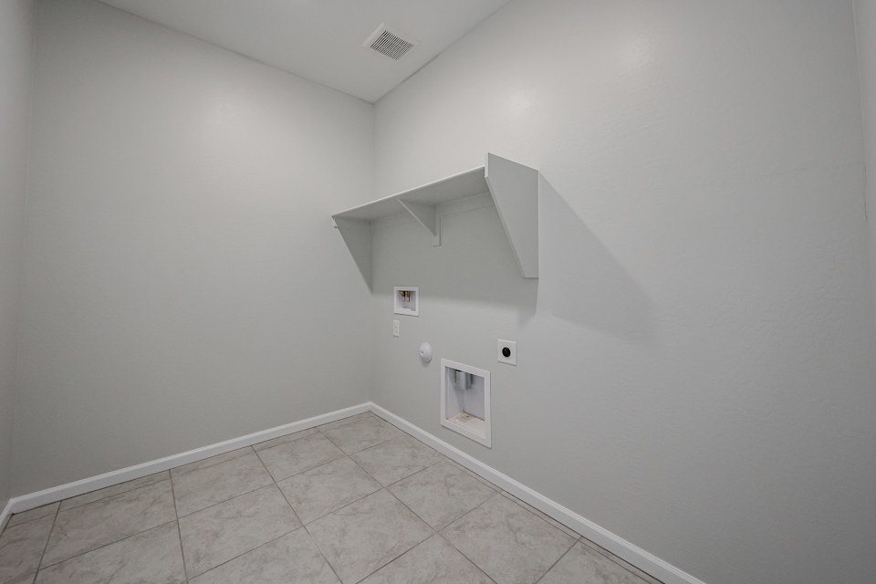 A white room with a tile floor.