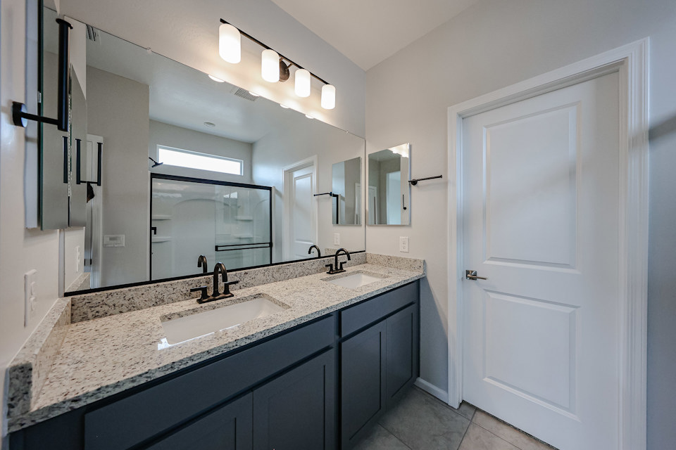 A bathroom with a marble countertop.
