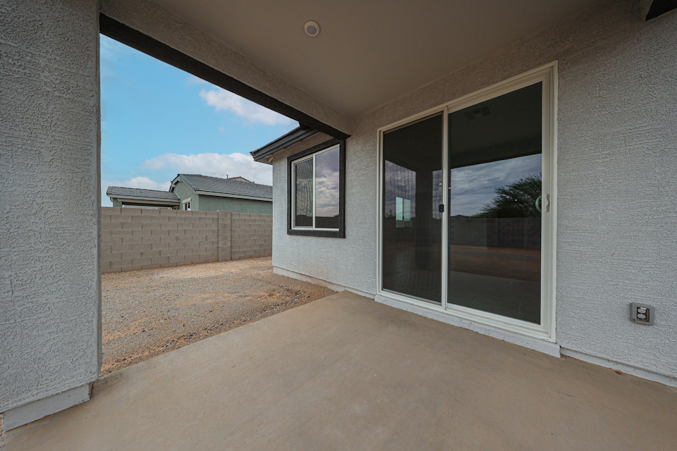 A room with windows and a rug.