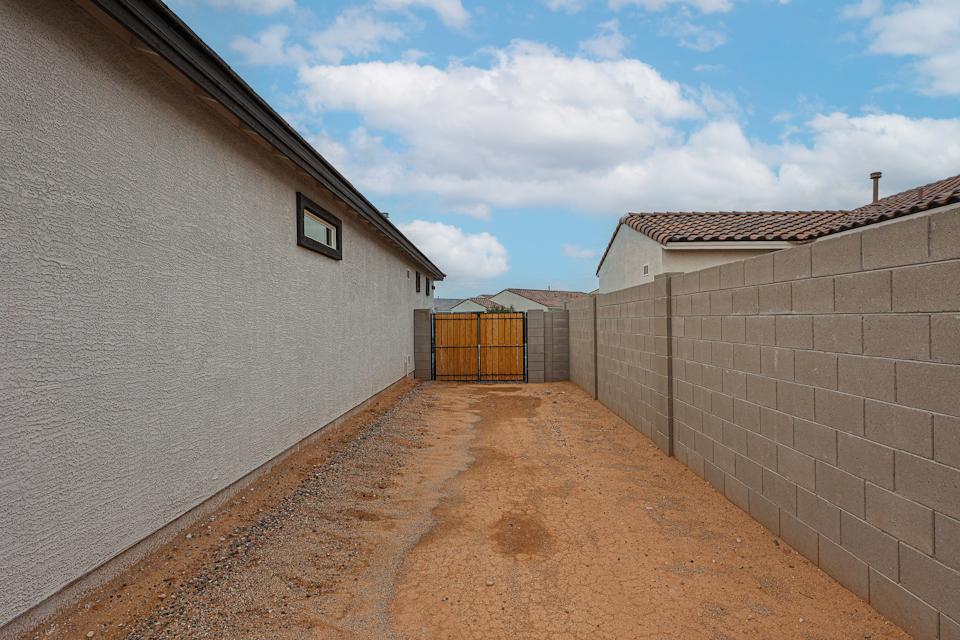 A building with a fence and a brick wall.